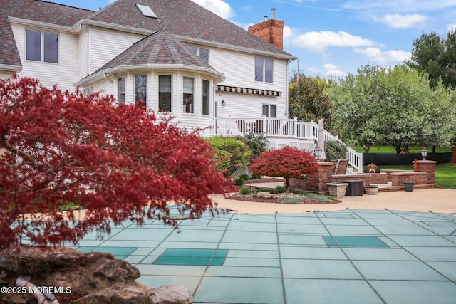 191 Robertsville Rd, Freehold, NJ 07728 - rear view of house with a chimney, a covered pool, stairway, and a patio area