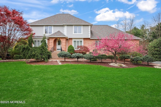 191 Robertsville Rd, Freehold, NJ 07728 - traditional-style house featuring a shingled roof, a front lawn, and brick siding