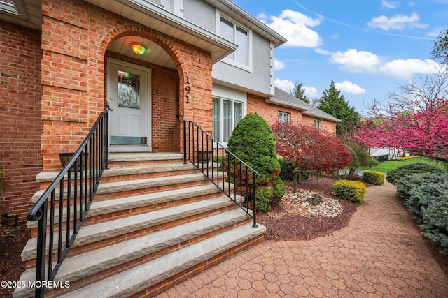191 Robertsville Rd, Freehold, NJ 07728 - view of exterior entry featuring brick siding and stucco siding