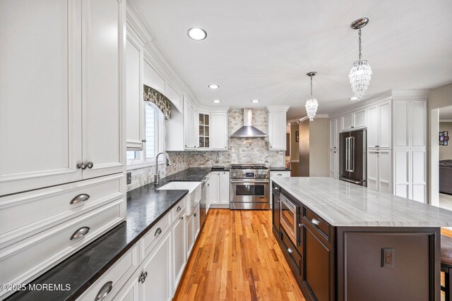 191 Robertsville Rd, Freehold, NJ 07728 - kitchen featuring white cabinets, an inviting chandelier, a sink, wall chimney exhaust hood, and high quality appliances