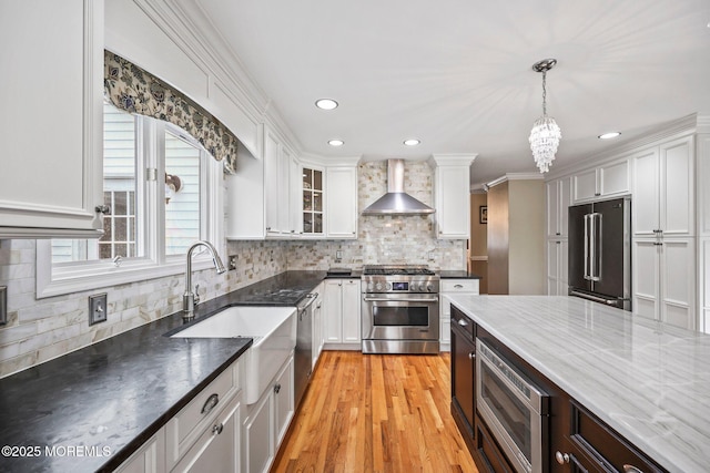 191 Robertsville Rd, Freehold, NJ 07728 - kitchen with white cabinets, high end appliances, hanging light fixtures, and wall chimney range hood