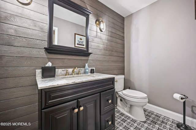 191 Robertsville Rd, Freehold, NJ 07728 - bathroom featuring vanity, wooden walls, baseboards, toilet, and tile patterned flooring
