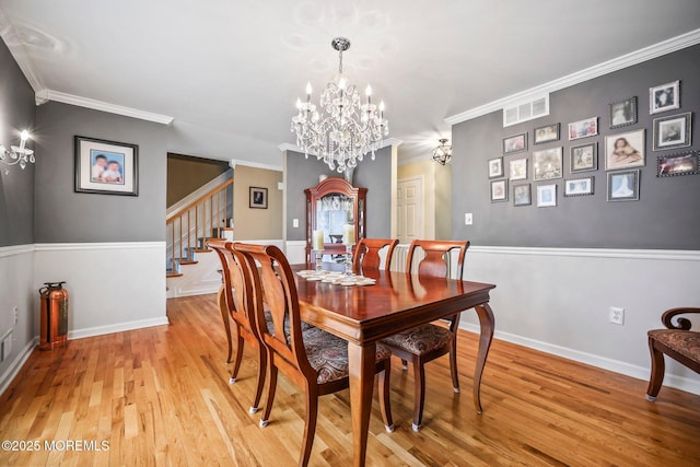 191 Robertsville Rd, Freehold, NJ 07728 - dining room featuring light wood finished floors, visible vents, an inviting chandelier, stairs, and ornamental molding