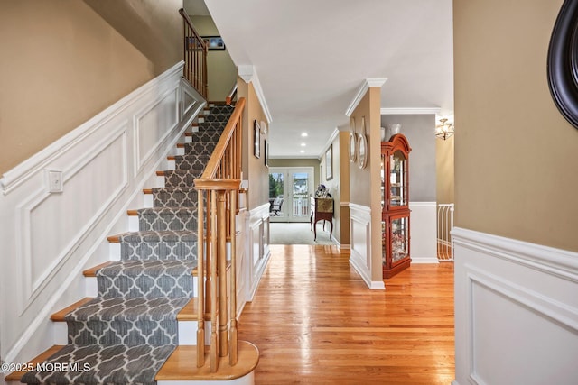 191 Robertsville Rd, Freehold, NJ 07728 - stairs with wood finished floors, a decorative wall, crown molding, and a wainscoted wall