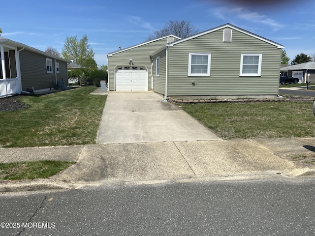 view of front of home featuring concrete driveway, a front yard, and an attached garage
