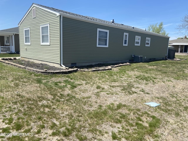 view of home's exterior featuring central AC unit, a yard, and crawl space