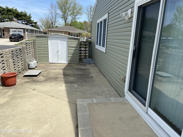 view of patio featuring an outdoor structure and a storage shed
