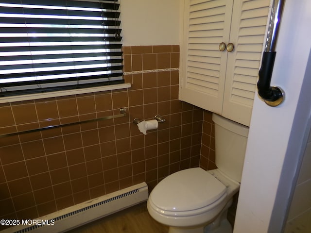 bathroom featuring baseboard heating and toilet