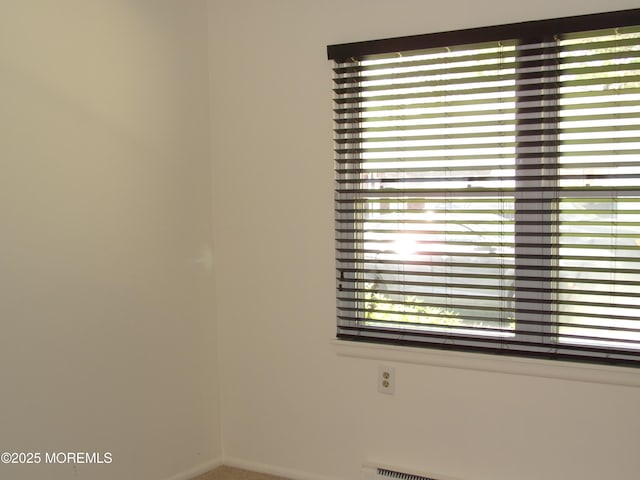 unfurnished room with a baseboard radiator
