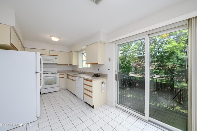 65 E River Rd Unit 14, Rumson, NJ 07760 - kitchen featuring light countertops, light tile patterned floors, and white appliances