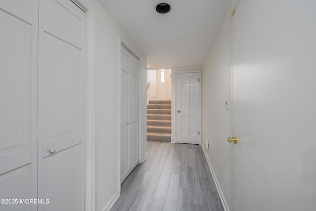 65 E River Rd Unit 14, Rumson, NJ 07760 - corridor featuring stairs, baseboards, and light wood-style floors