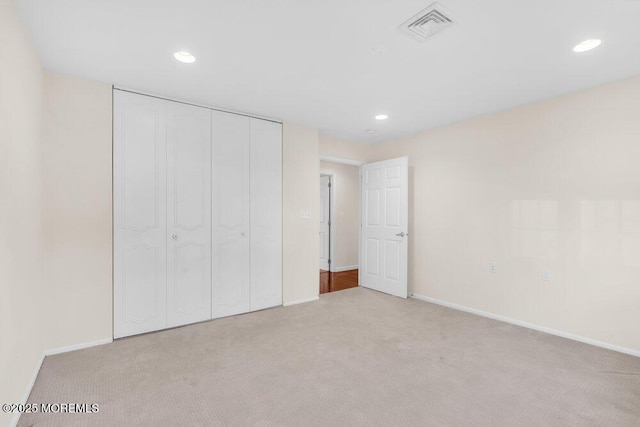 unfurnished bedroom with recessed lighting, visible vents, and carpet flooring