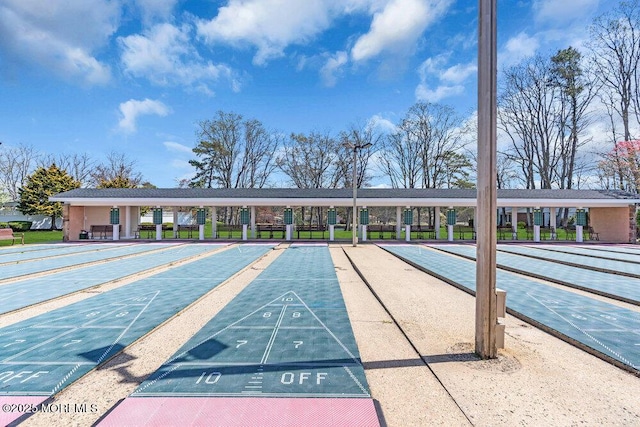 surrounding community with uncovered parking and shuffleboard