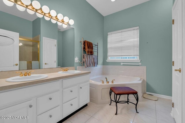 bathroom featuring a sink, double vanity, a shower stall, and a garden tub