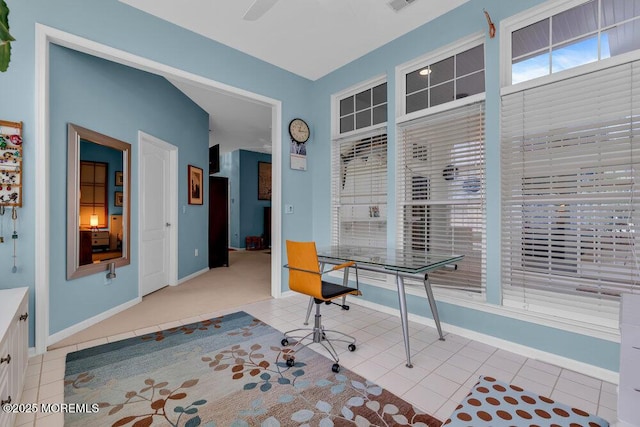 office space with baseboards and light tile patterned flooring