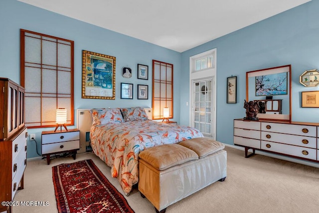 bedroom with baseboards and carpet