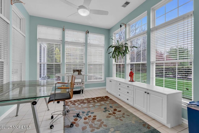 office space with visible vents, a ceiling fan, baseboards, and light tile patterned floors