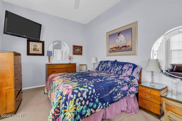 bedroom with a ceiling fan, baseboards, and light colored carpet