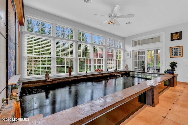 sunroom with visible vents and a wealth of natural light