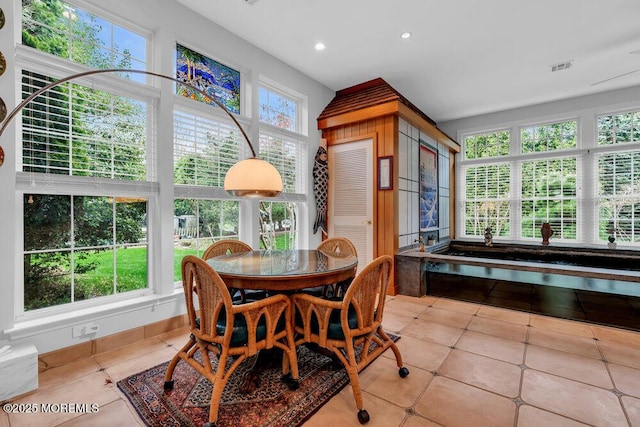 sunroom / solarium featuring tile patterned floors, recessed lighting, and visible vents