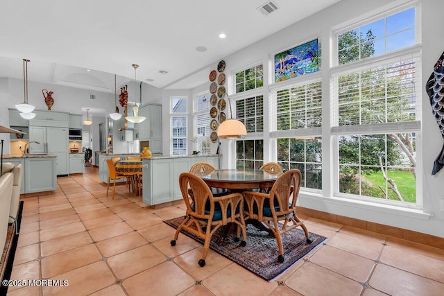 dining space featuring light tile patterned flooring and visible vents