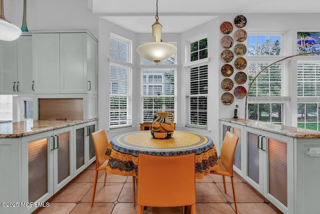 dining space with light tile patterned floors and a wealth of natural light
