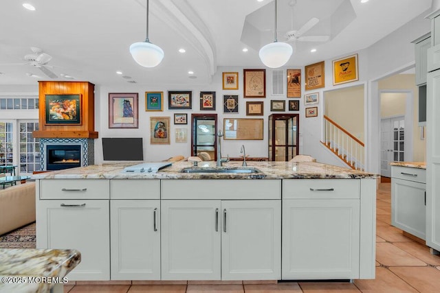 kitchen with recessed lighting, a ceiling fan, a sink, and open floor plan