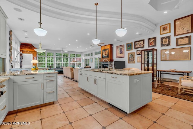 kitchen featuring recessed lighting, a sink, pendant lighting, and open floor plan
