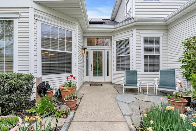 view of exterior entry with a patio