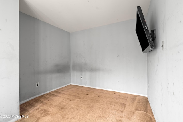 carpeted spare room with baseboards