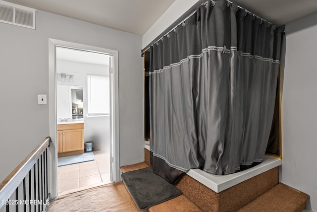 full bathroom with tile patterned floors, vanity, a shower with shower curtain, and visible vents