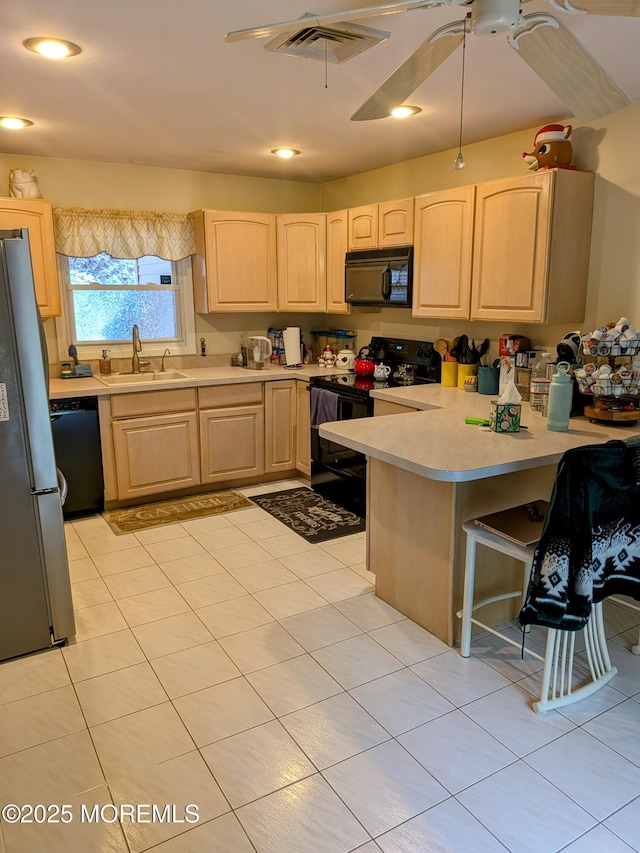 59 Chilton Ln, Aberdeen, NJ 07747 - kitchen with black appliances, light brown cabinetry, and light countertops