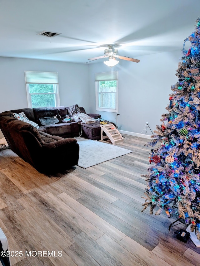 59 Chilton Ln, Aberdeen, NJ 07747 - living room with healthy amount of natural light, wood finished floors, and ceiling fan
