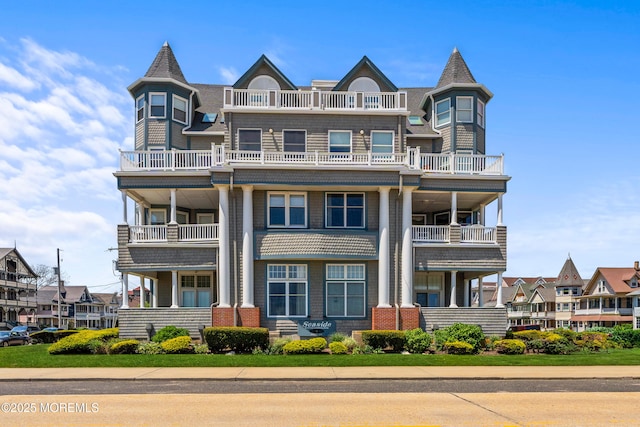 view of front of house featuring a balcony