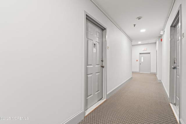 corridor with light colored carpet, baseboards, and recessed lighting