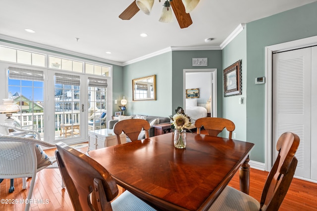 dining space with a ceiling fan, crown molding, wood finished floors, recessed lighting, and baseboards