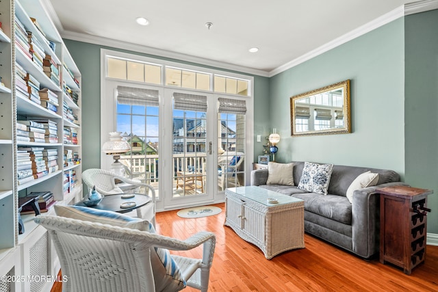 living room with crown molding, light wood finished floors, and recessed lighting