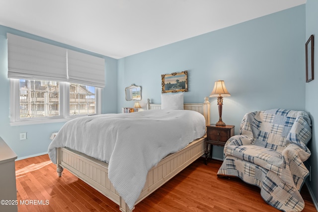 bedroom featuring wood finished floors and baseboards