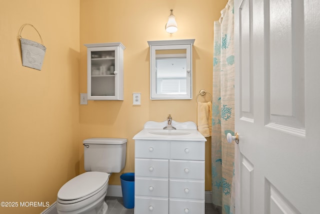 bathroom featuring tile patterned floors, toilet, vanity, and baseboards