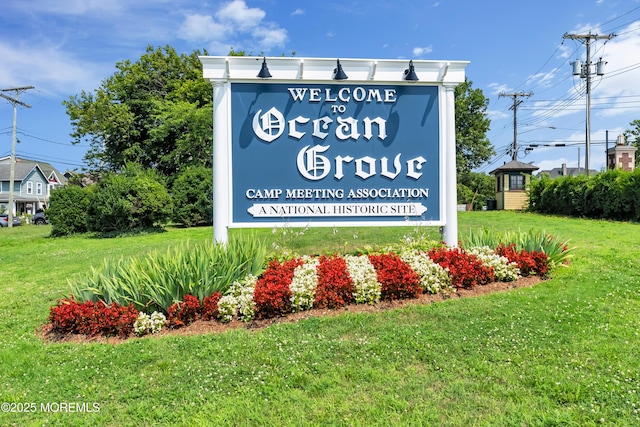 community sign featuring a lawn