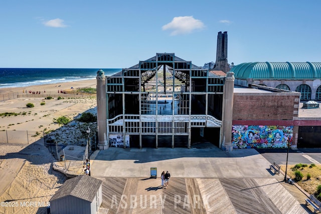 view of property featuring view of water and beach