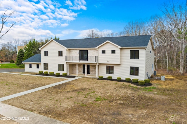 modern farmhouse style home with a balcony