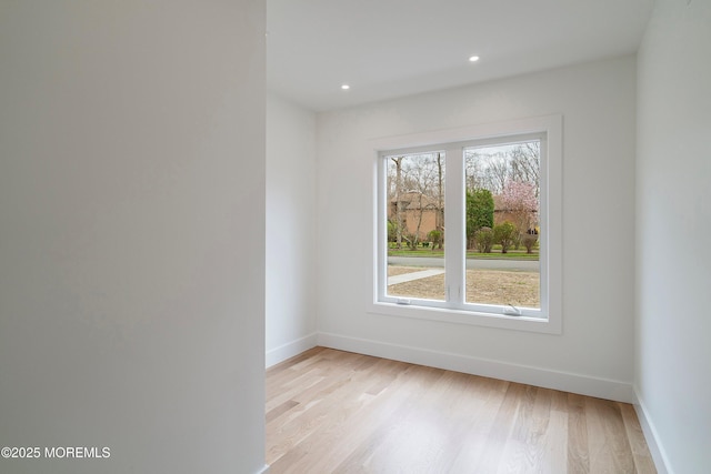 unfurnished room with baseboards, light wood-style floors, and recessed lighting