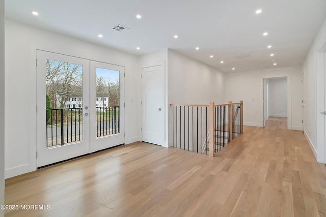 interior space featuring french doors, baseboards, recessed lighting, and light wood-style floors