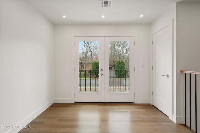 entryway featuring wood finished floors, french doors, visible vents, and recessed lighting