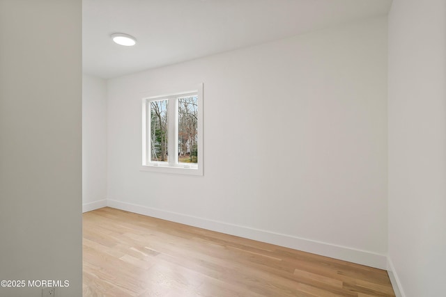 unfurnished room with light wood-style flooring and baseboards