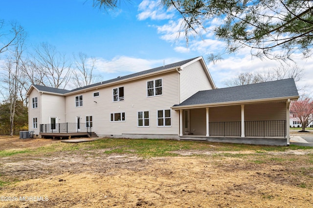 back of property with a shingled roof, covered porch, and central air condition unit