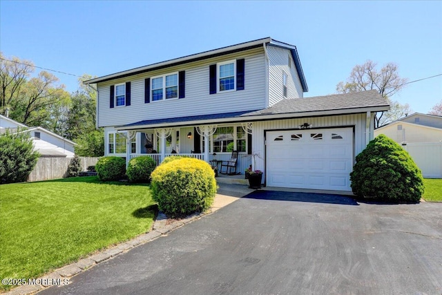 view of front of property with a front lawn, aphalt driveway, fence, an attached garage, and a porch