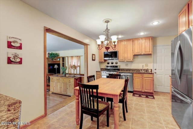 dining space with recessed lighting and a chandelier