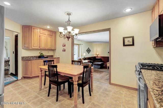 dining space with baseboards, recessed lighting, and a chandelier